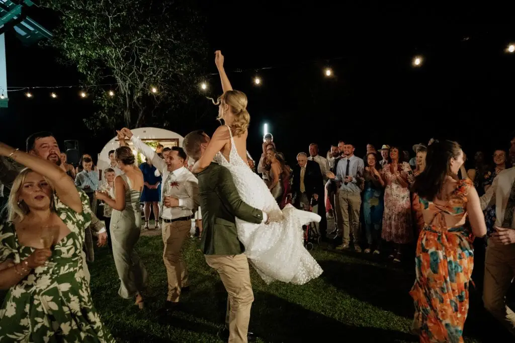 Wedding party dancing outdoors at night