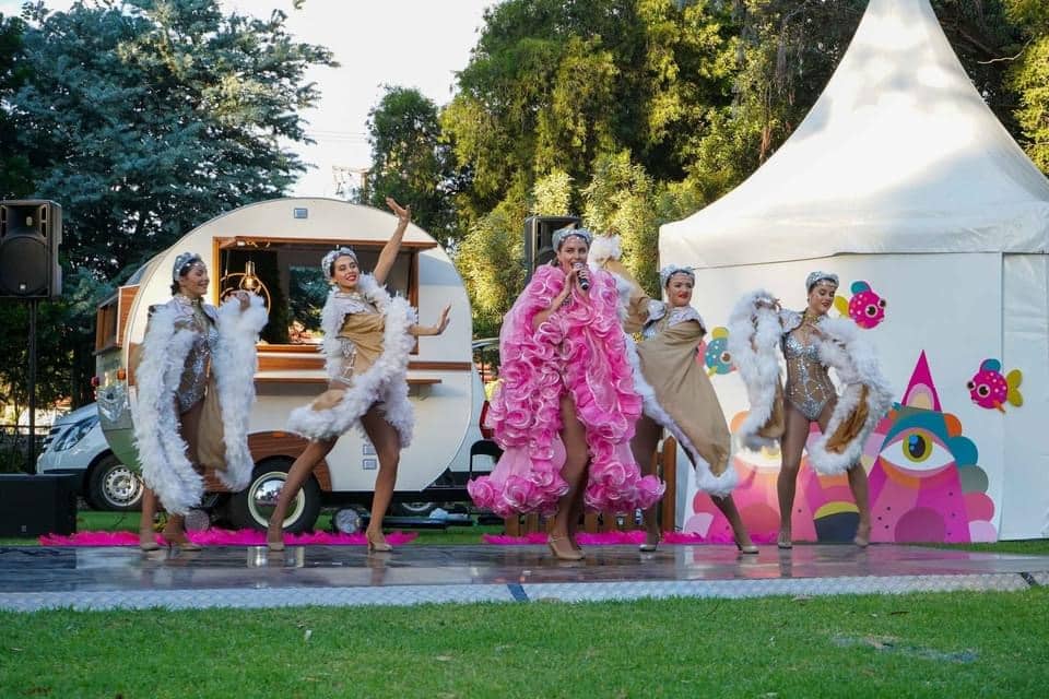 Performers in feathered costumes dancing