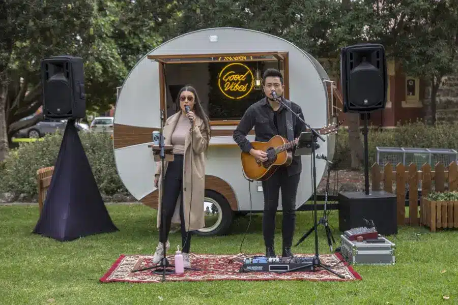 Musicians perform near food truck