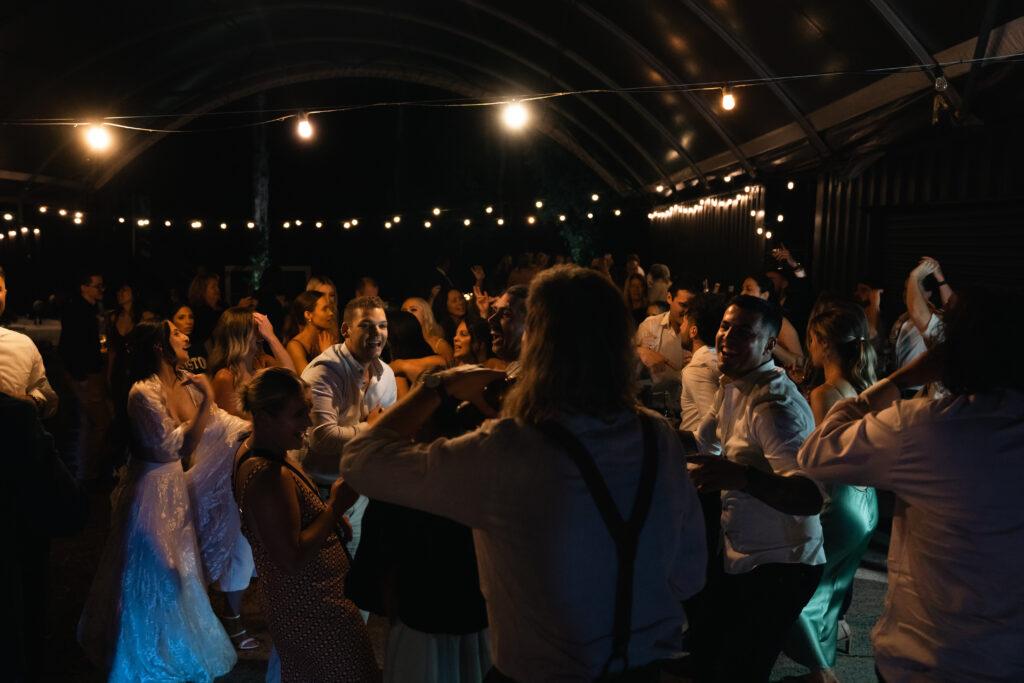 People dancing under string lights